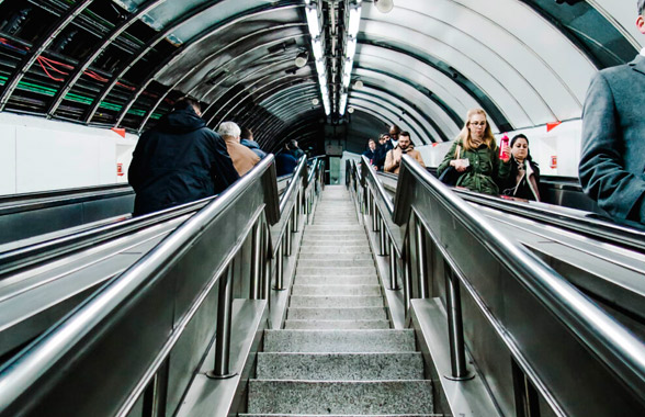 Escada em metrô iluminado.