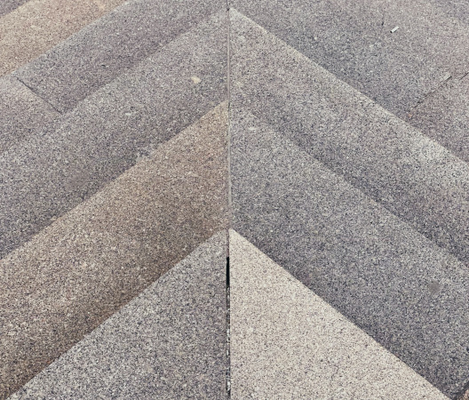 Close-up of textured grey construction material arranged in a chevron pattern