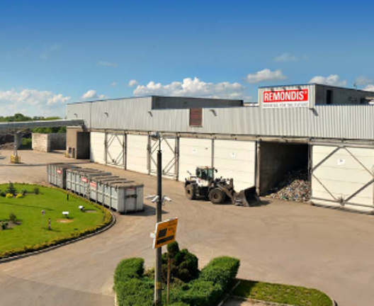 Waste processing and recycling facility with heavy machinery handling materials