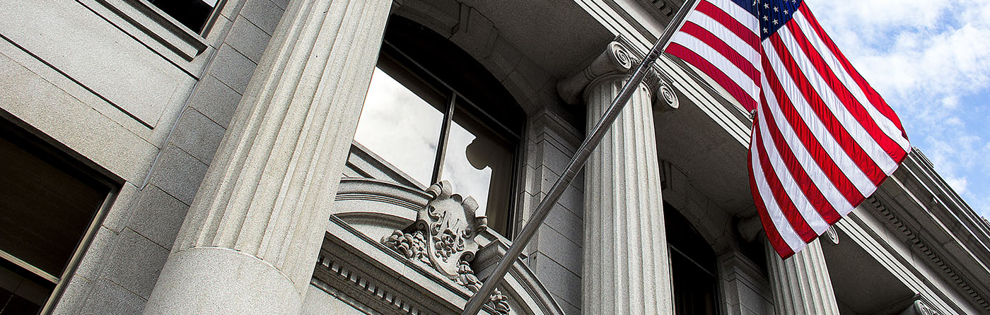 Facade of US Government building with American flag flying