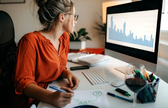 woman looking at data on a computer