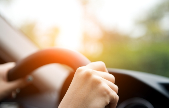 woman's hand on the steering wheel