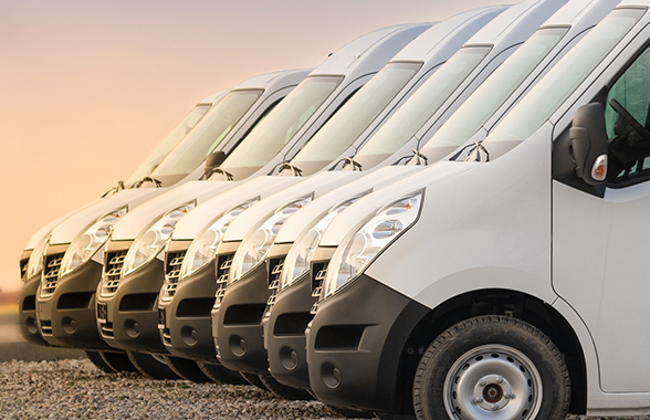 fleet of commercial electric vehicles parked in a row