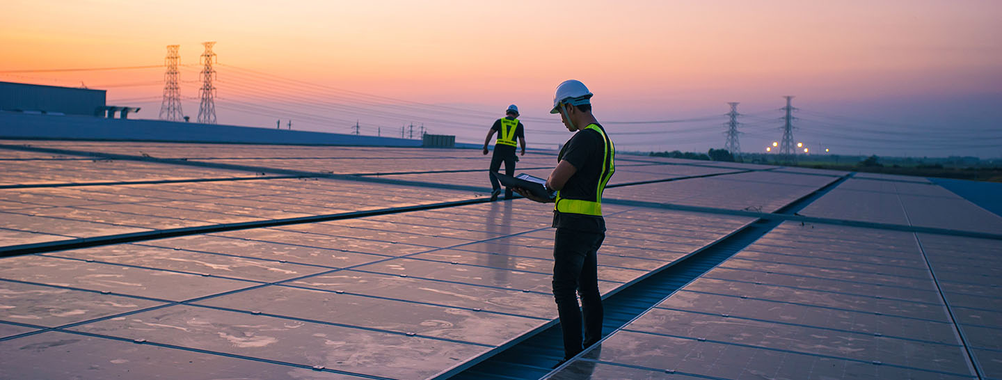 Rooftop solar with workers at sunset