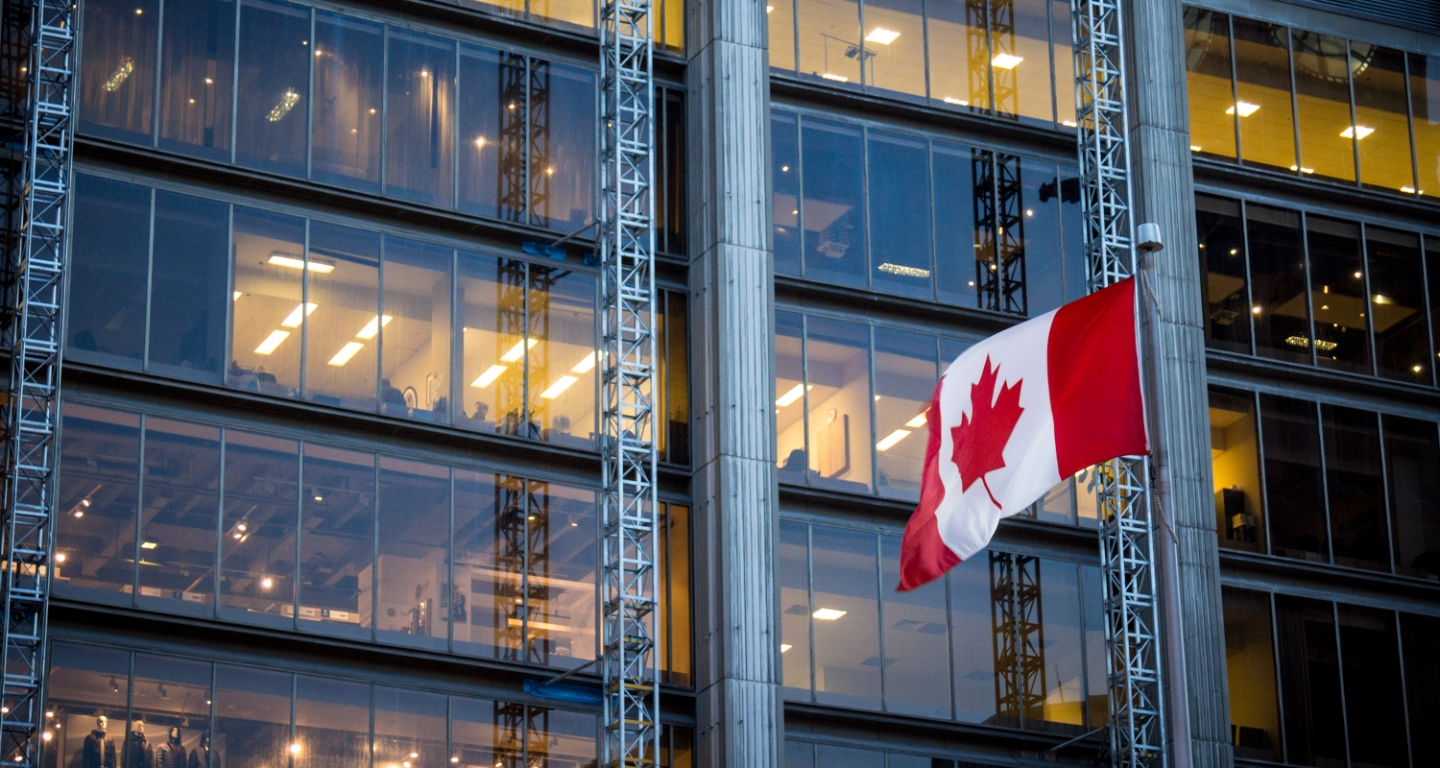 City building with Canadian flag flying