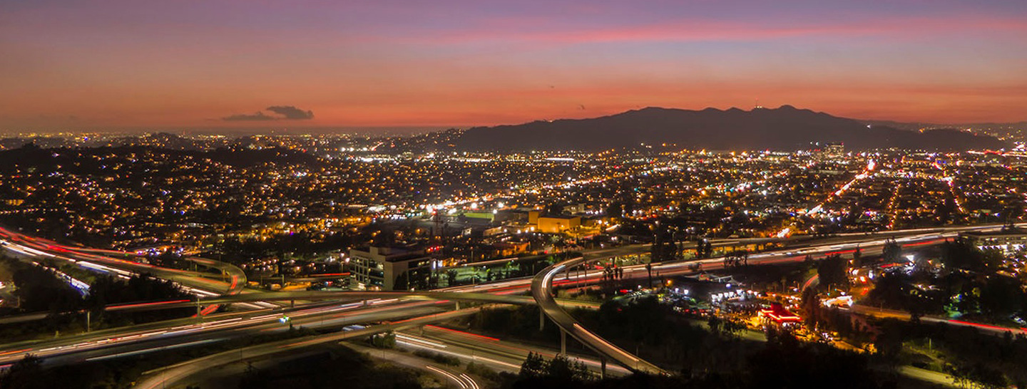 Aerial view of busy city and highway at night