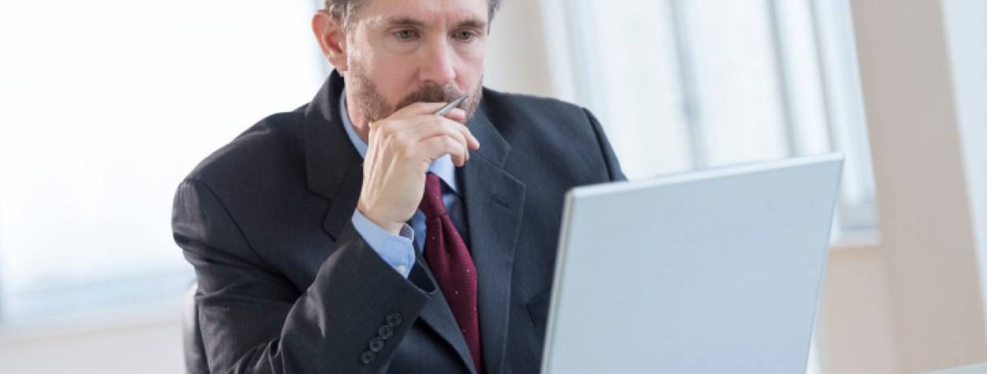 Businessman looking at laptop screen