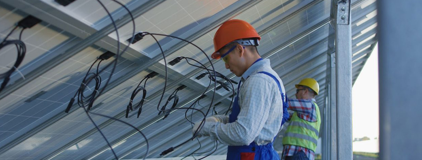 Electricians working on solar panels