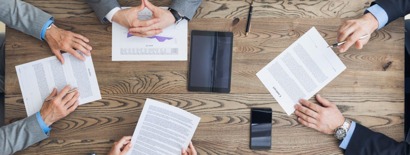 Hands in a meeting on a desk