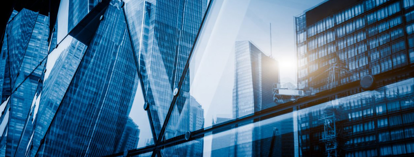 Buildings reflected in glass.