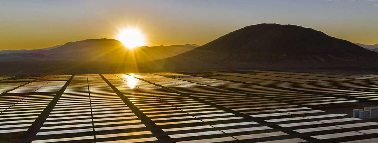 Sun setting over solar panels