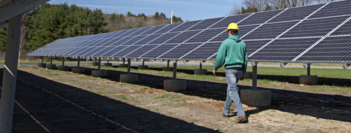 Man walking near solar panels