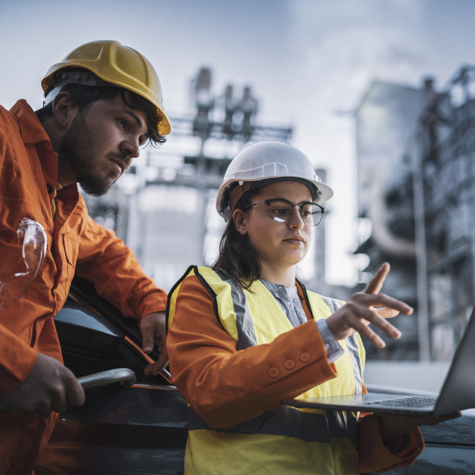 Engineers reviewing operational data at an industrial energy facility