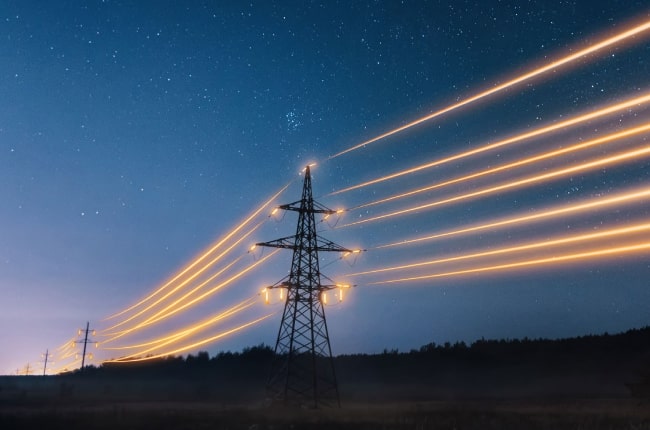 pylon holding shining cables at night