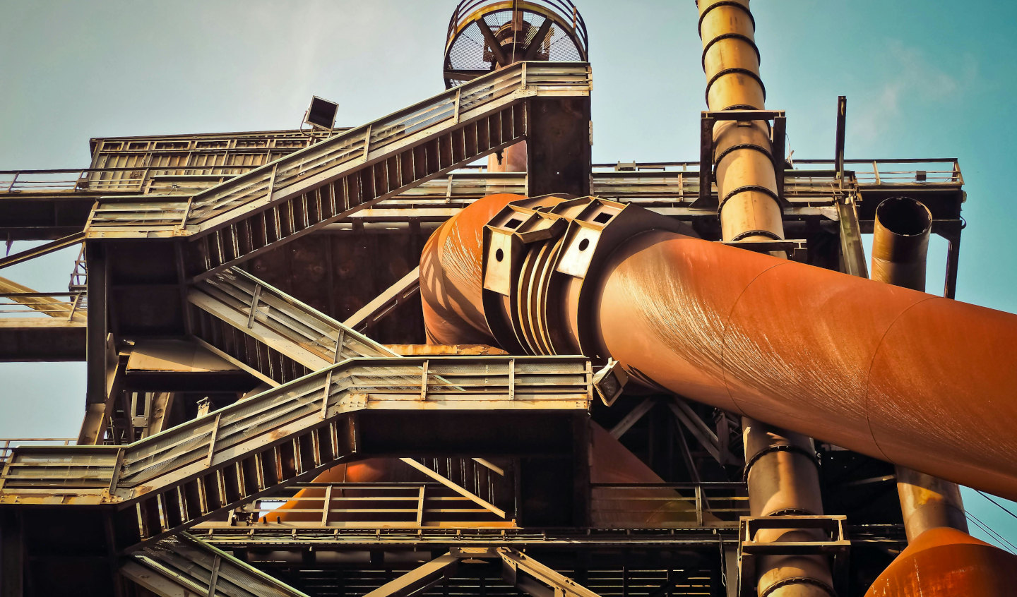 Industrial facility with large pipeline, conveyor systems and metal structures